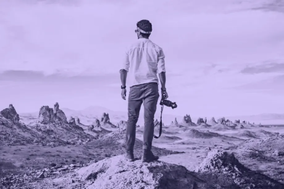 A lone figure standing in a vast open landscape